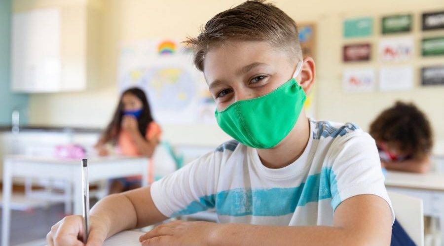 Bambino a scuola con la mascherina