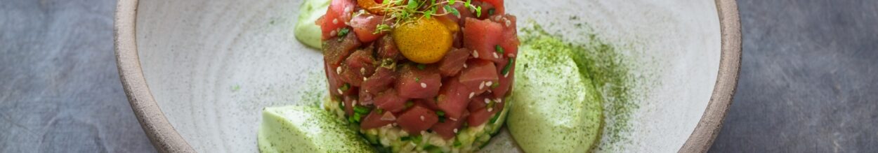 Fresh tuna tartar with lime, avocado sauce and yolk, restaurant dish