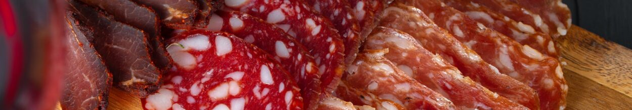 Wooden platter with meat cuts close up