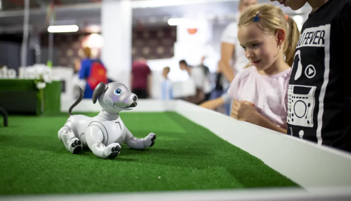 little girl playing with robot in edenlandia