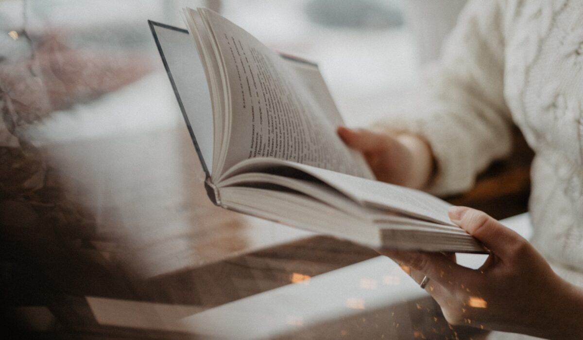 girl reading a book / holding a book