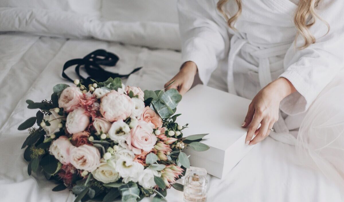 Bride holding white box for morning boudoir