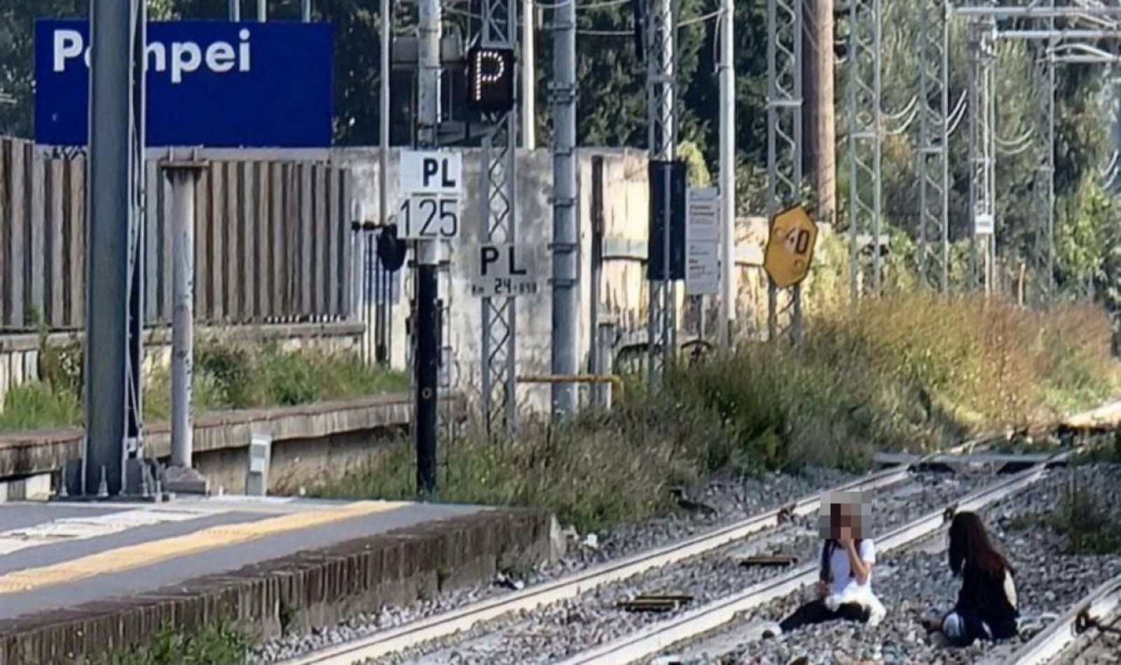 Girls lying on tracks in Pompeii