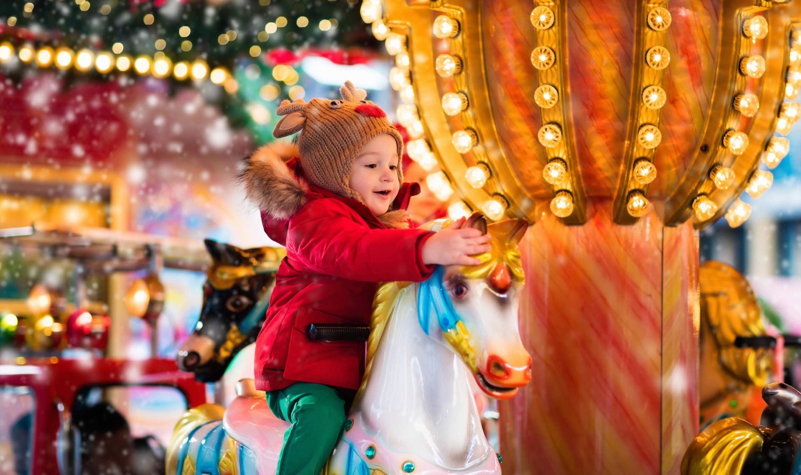 child playing on Christmas carousel