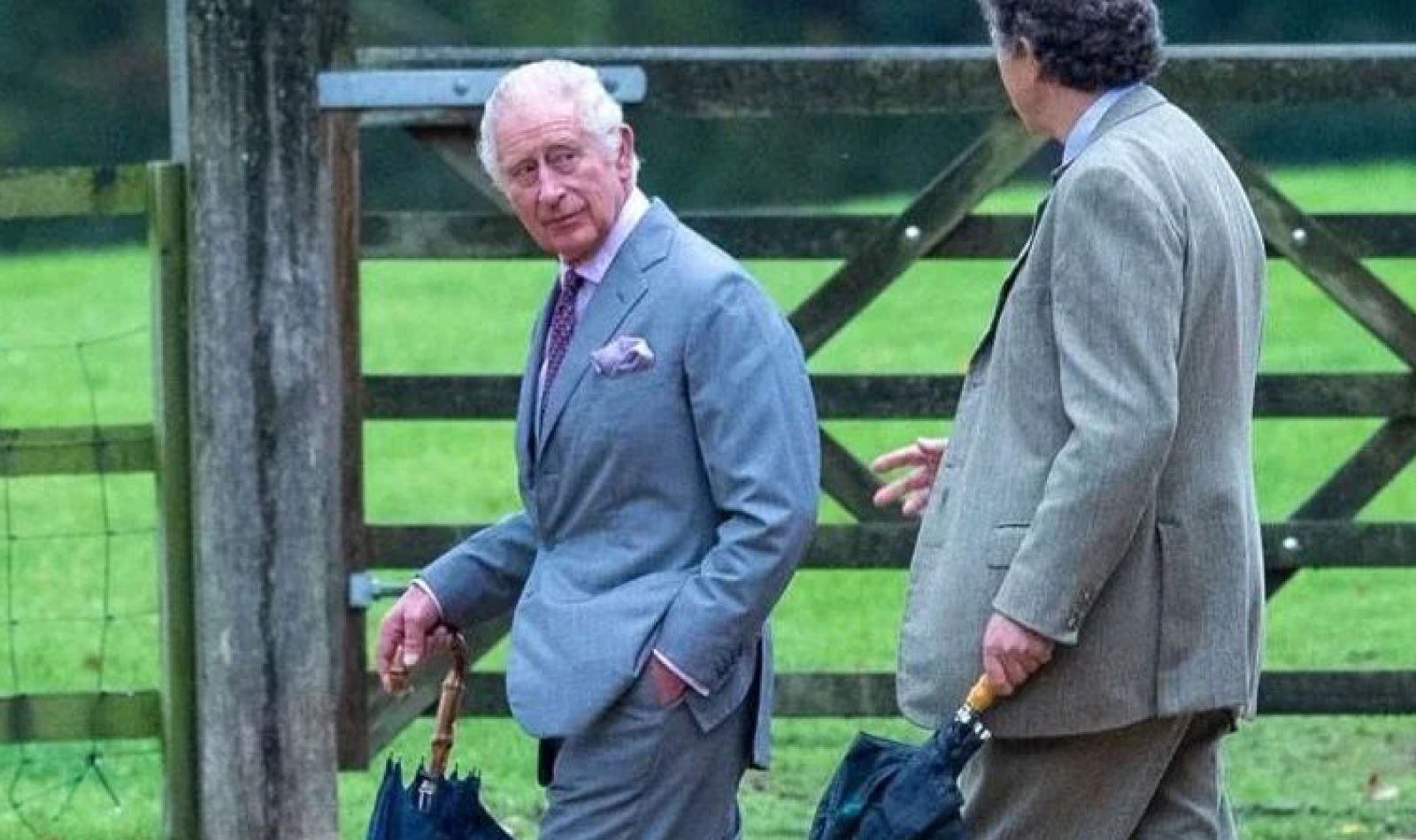 King Charles holding Talarico's umbrella