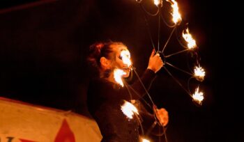 ↟ Fire show. Fire dancer dances. Night performance. Dramatic portrait. Fire and smoke