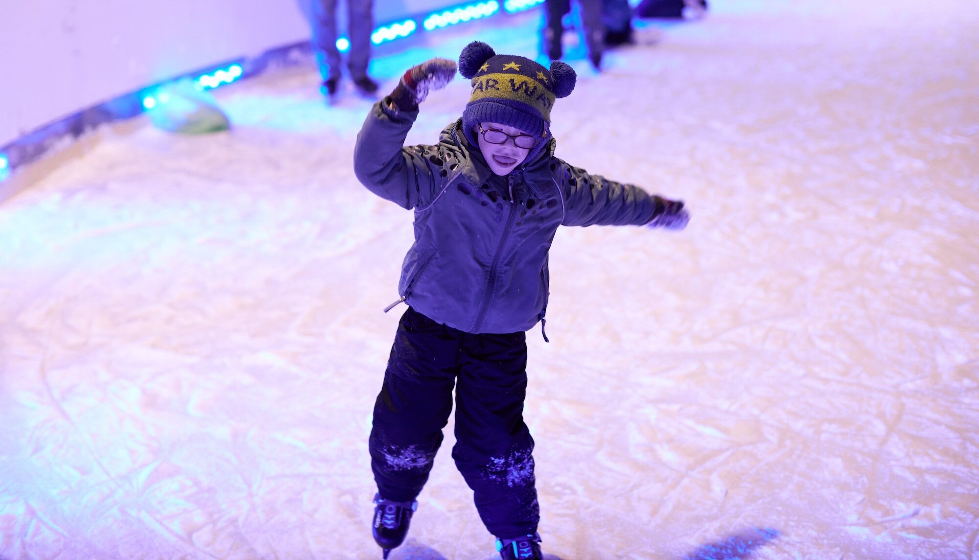 Child skating on the ice rink