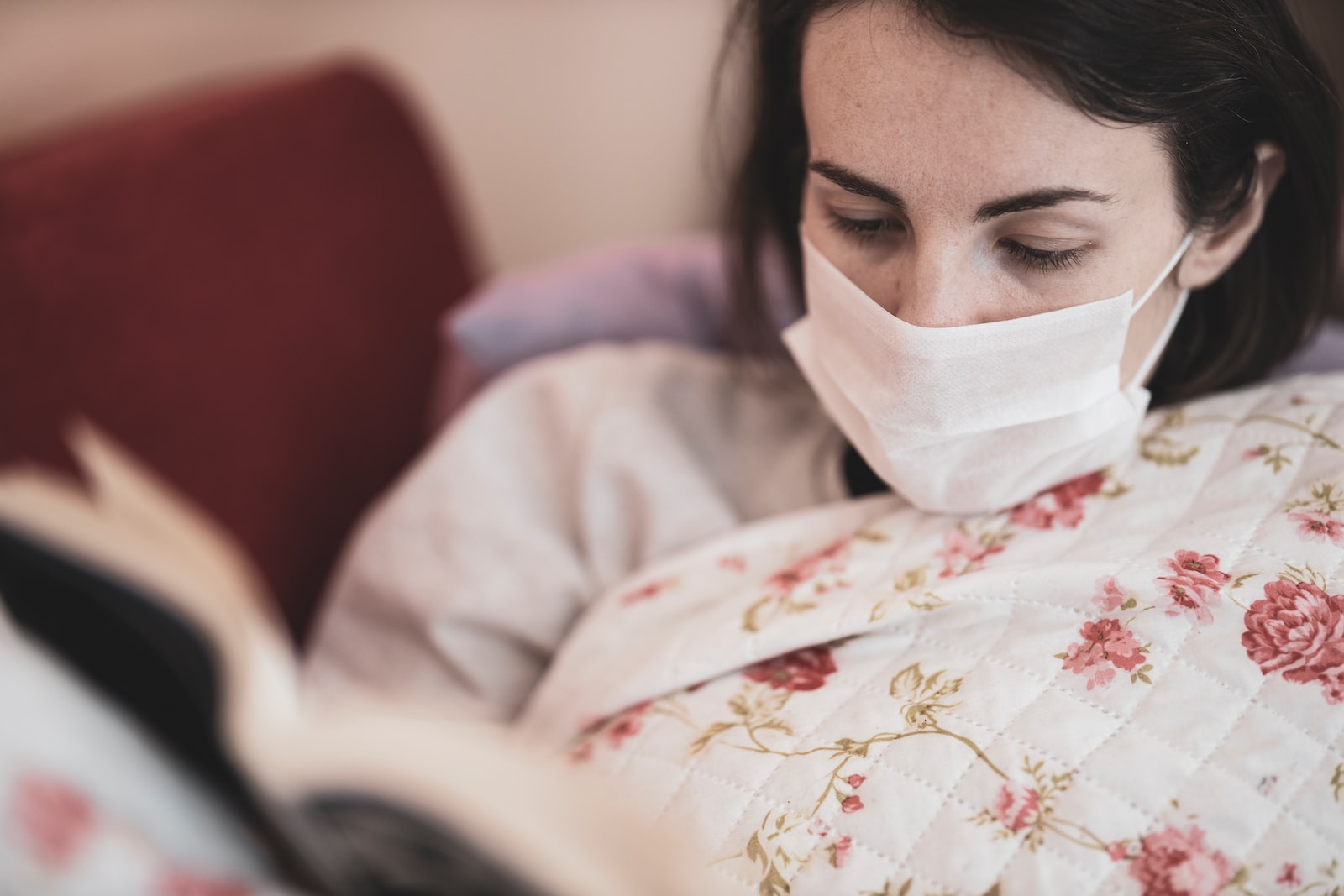 A sick woman reading a book