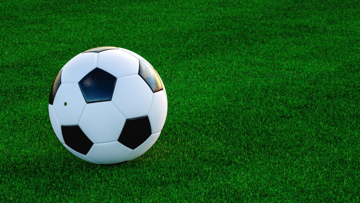 Football ball on grassy field