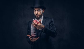 Magician showing trick with playing cards.