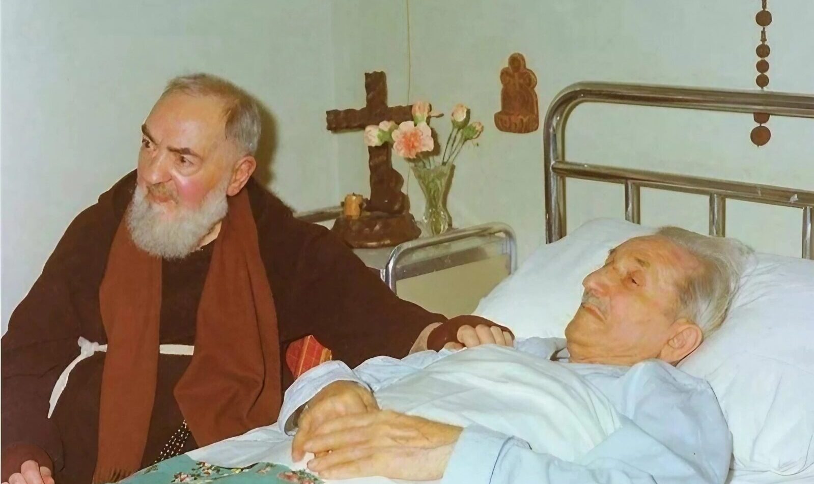 Padre Pio comforts a sick person