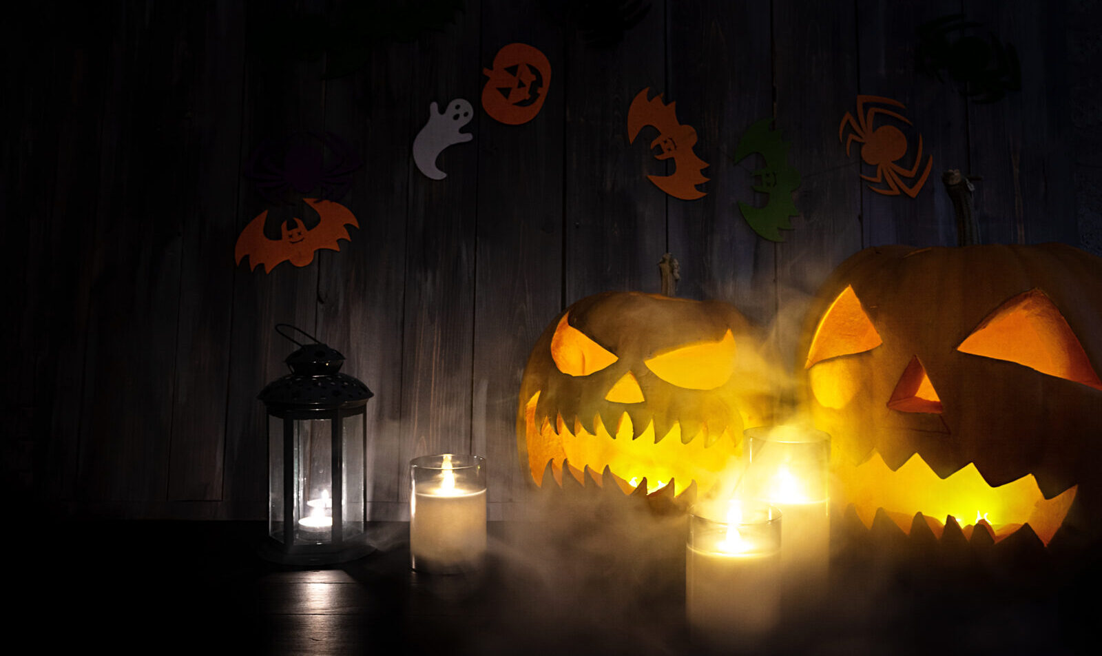 Halloween background with pumpkin head lantern and candles. Halloween pumpkin Jack-o-Lantern