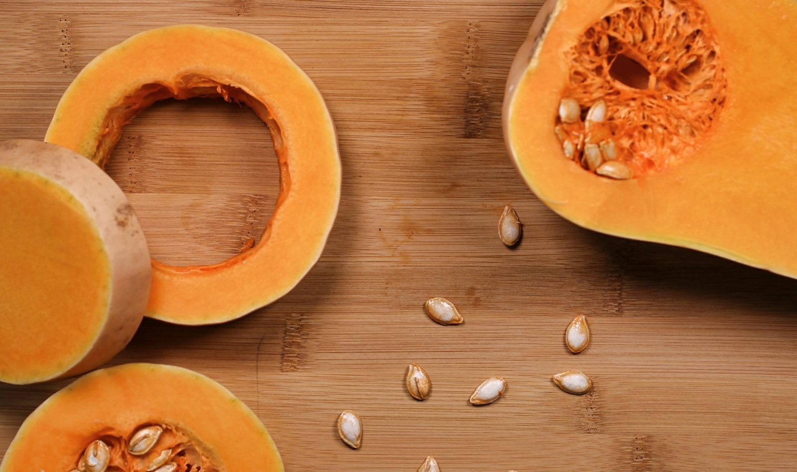 sliced ​​pumpkin on brown wooden surface