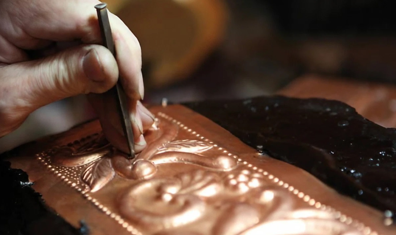 Woman performing the embossed engraving technique